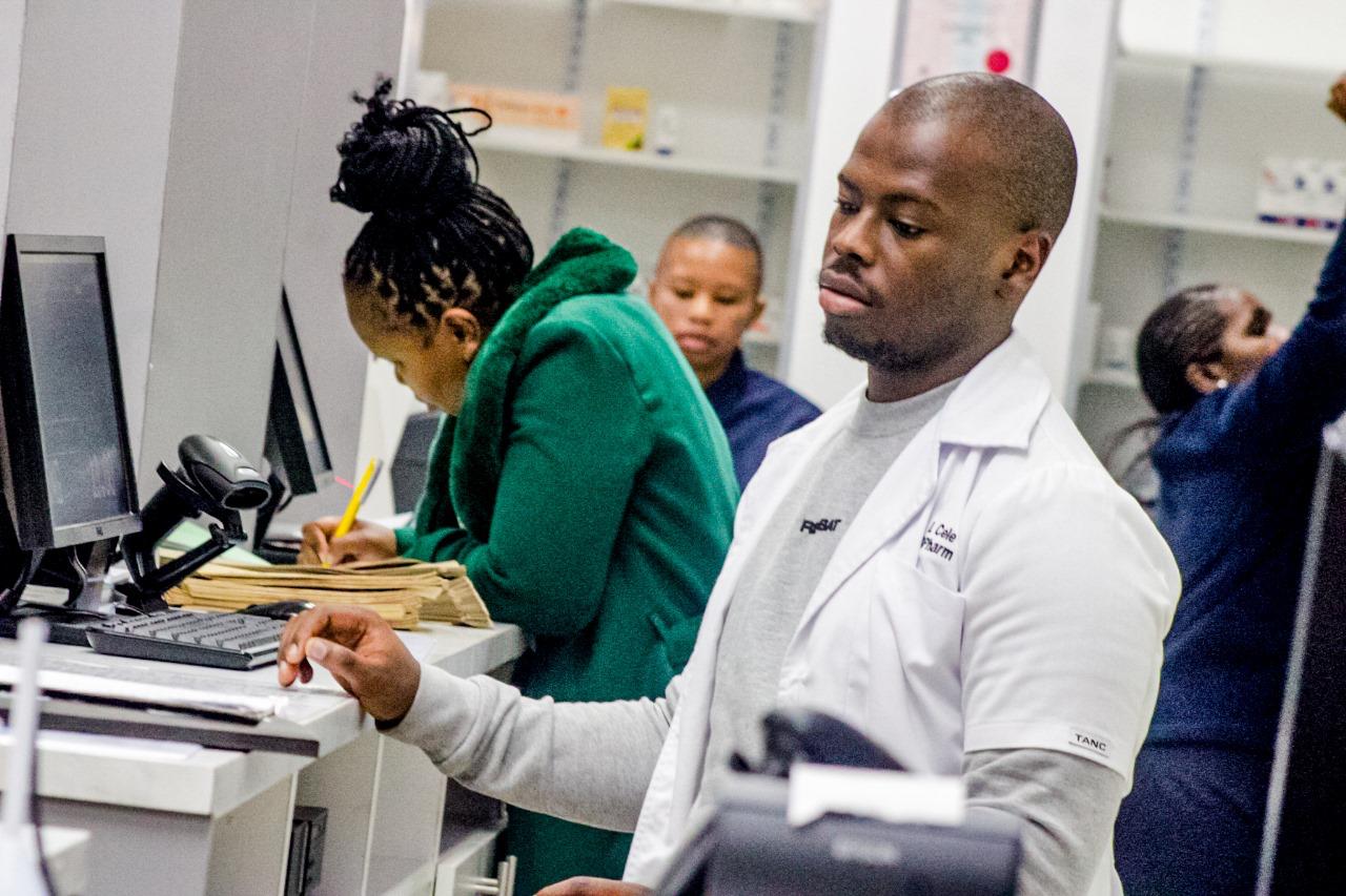 Divine Inspiration pharmacy professional serving a patient